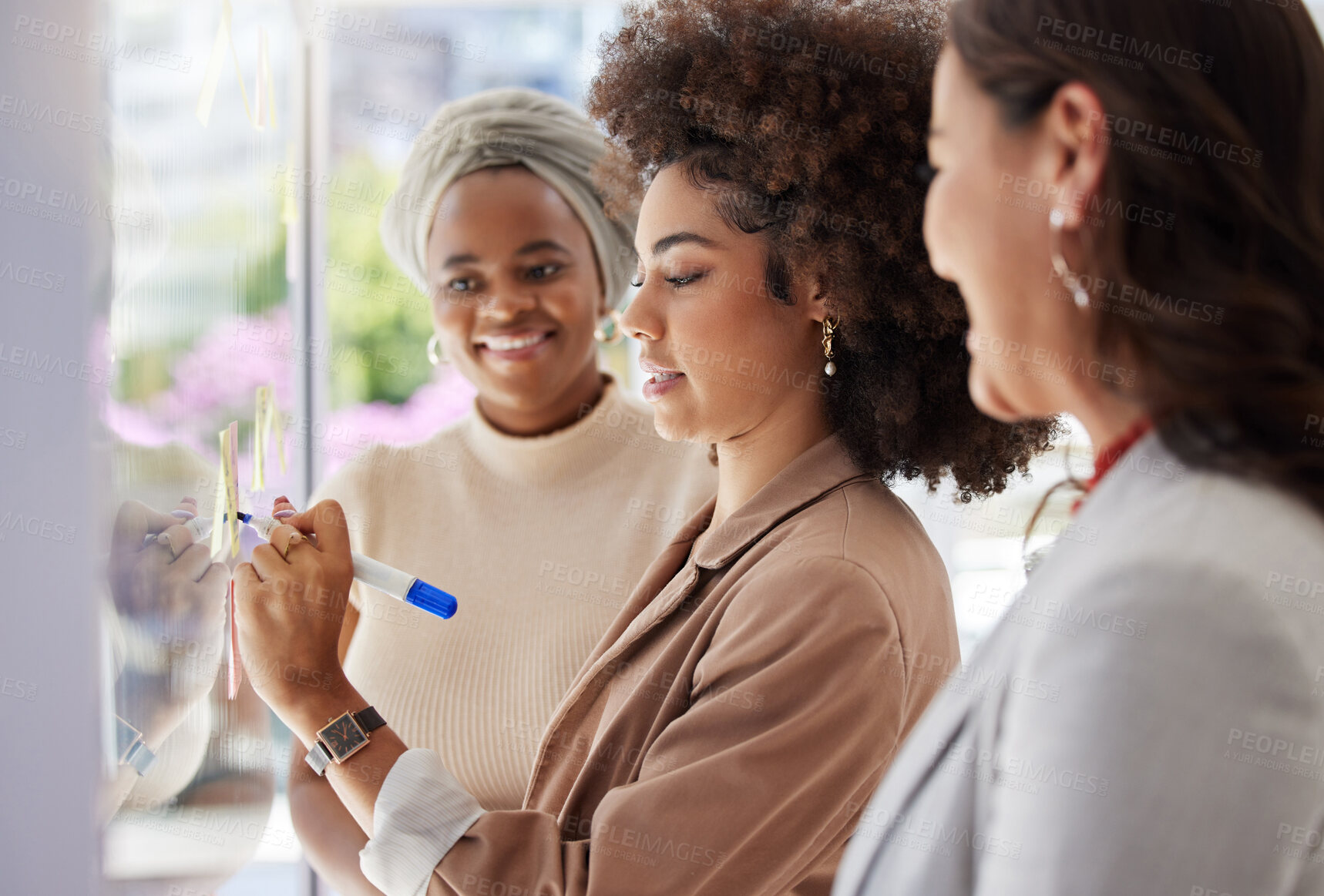 Buy stock photo Planning, happy and women brainstorming in a meeting, writing ideas and notes on a sticky note. Smile, agenda and business people speaking while working on a strategy and explaining a concept