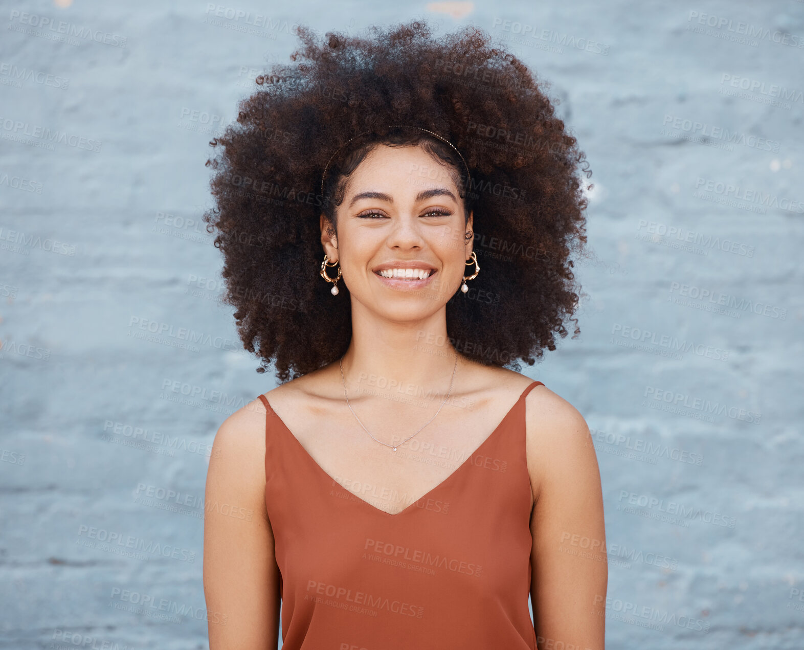 Buy stock photo Portrait, happy woman and smile on brick wall background with happiness and joy. Face, confident and beauty of young, excited and mixed race person, girl or female from South Africa standing alone.