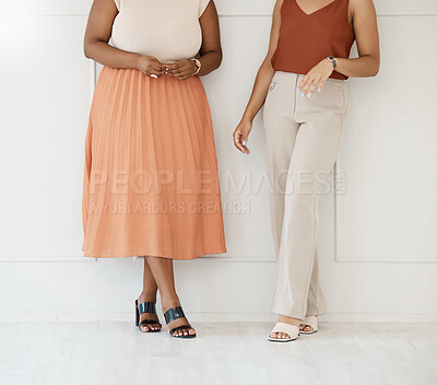 Buy stock photo Fashion, formal and business woman friends at office against a wall in team conversation or chat. Discussion, planning and legs of professional corporate employee women in luxury outfits at workplace