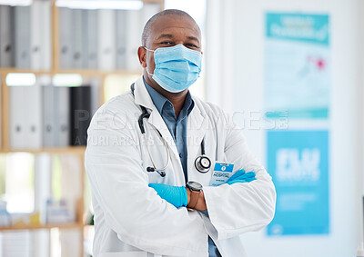 Buy stock photo Covid, portrait and a doctor black man in a hospital office, standing arms crossed for healthcare or insurance. Medical, mask and trust with a male medicine professional at work in a wellness clinic