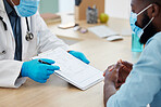 Doctor and patient talking about covid test results in a consult. African american doctor wearing a face mask to protect from corona in a checkup. Patient looking at medical report on a chart