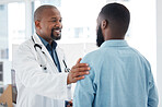 Mature doctor giving a patient support. African american doctor touching a patient on the arm. Patient in a consult with his doctor. Caring doctor giving a patient comfort and support.
