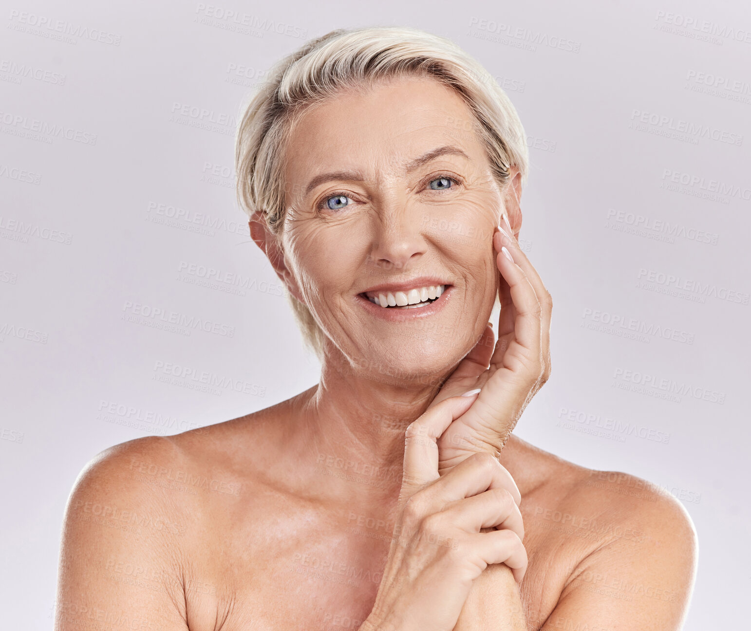 Buy stock photo Portrait of happy smiling mature caucasian woman looking positive and cheerful against studio background. Smooth face and skin of an older female or antiaging beauty model doing her skincare routine