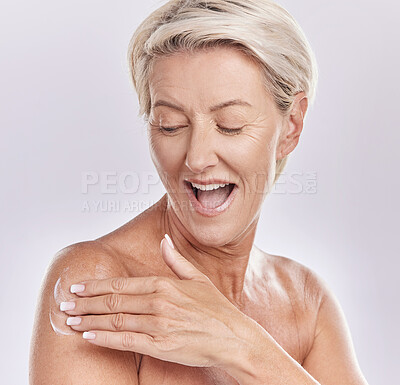 Buy stock photo Beauty, bodycare and woman applying lotion for skincare routine applying lotion on her body. Studio portrait of a happy and excited senior female with glowing and smooth skin using anti aging cream