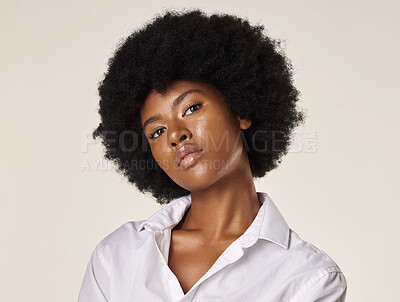 Buy stock photo Studio portrait of a young stunning African American woman with a beautiful afro. Confident black female model showing her smooth complexion and natural beauty while posing against a grey background