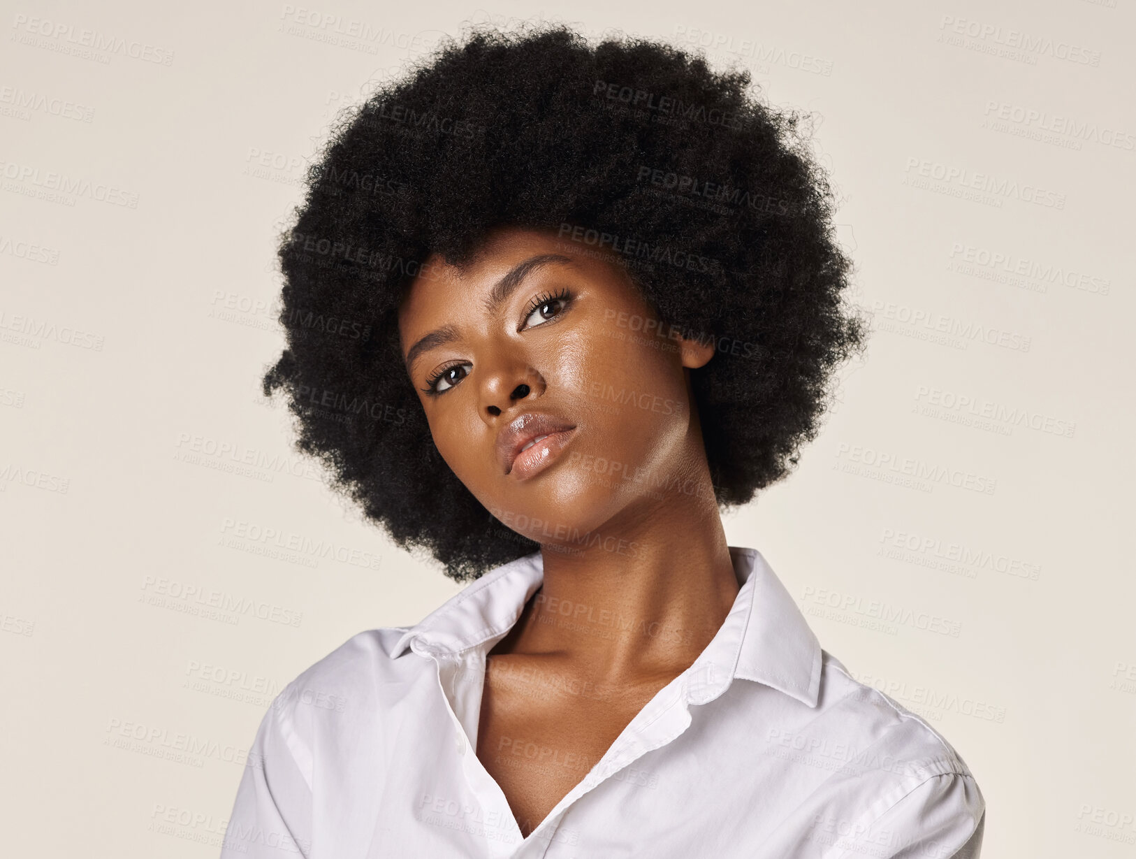 Buy stock photo Studio portrait of a young stunning African American woman with a beautiful afro. Confident black female model showing her smooth complexion and natural beauty while posing against a grey background