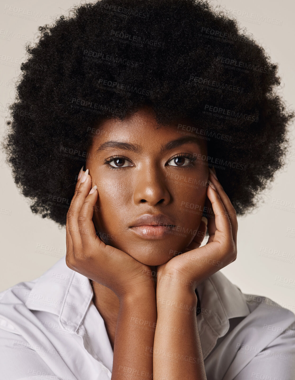 Buy stock photo Studio portrait of a young stunning African American woman with a beautiful afro. Confident black female model showing her smooth complexion and natural beauty while posing against a grey background