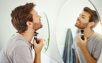 Buy stock photo Mirror reflection, grooming and man shaving in the bathroom of a home in the morning for personal hygiene. Electric razor, skincare and routine with a young male person in his house for hair removal