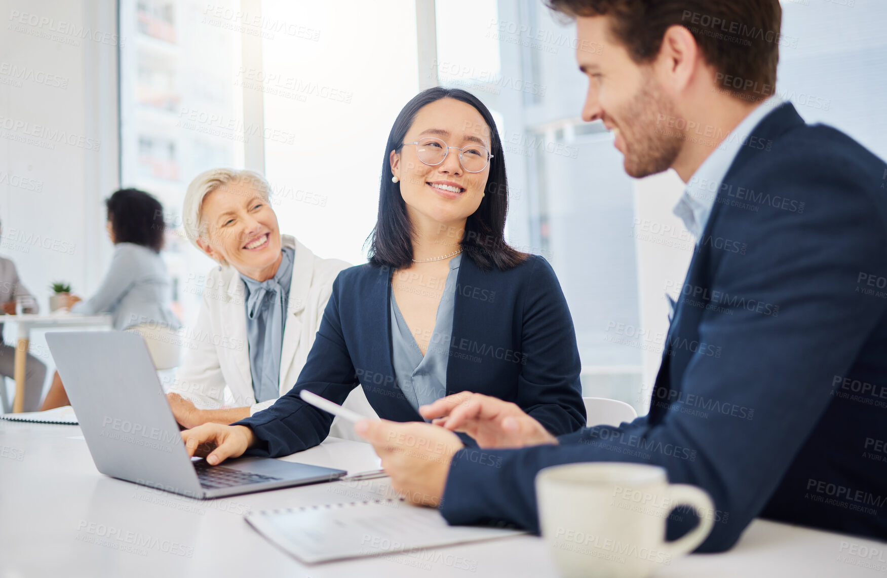 Buy stock photo Teamwork, young asian businesswoman on a laptop and talking to colleagues in an office. Happy diverse businesspeople, coordination or collaboration and planning for success with digital devices 