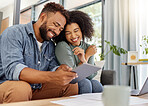 Young happy mixed race couple going through documents and using a digital tablet at a table together at home. Cheerful hispanic husband and wife smiling while planning and paying bills. Boyfriend and girlfriend working on their budget