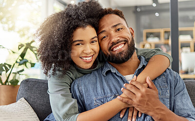 Buy stock photo Portrait of a happy mixed race couple embracing while relaxing at home. Hispanic boyfriend and girlfriend smiling while spending time together in the lounge at home