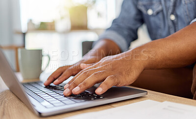 Buy stock photo Closeup of a man’s hand typing an email while working on a laptop alone at home. One person using a laptop on a table in the lounge at home