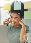 Young happy mixed race woman on a call with her phone while working a laptop sitting at a table at home. Joyful hispanic female with a curly afro laughing while talking on the phone alone in the lounge at home