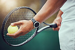Closeup of one unknown indian tennis player getting ready to serve on court. Ethnic fit athlete holding a racket and a ball during match. Active and healthy man playing a game as exercise and training