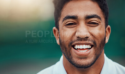 Portrait headshot of smiling indian tennis player on court with copyspace. Happy fit ethnic sports professional standing alone and feeling confident in sports club. Ready for athletic and healthy game