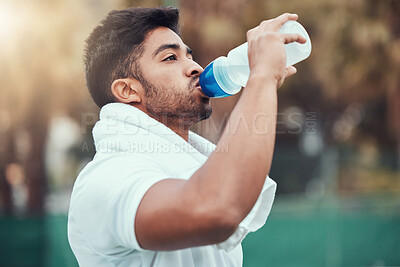 Buy stock photo Man, fitness and drinking water on tennis court after workout, match or game practice outdoors. Thirsty male person or sports player with drink bottle for healthy wellness, hydration or resting break