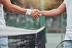 Two unknown ethnic tennis players shaking hands before playing court game. Fit athletes team standing and using hand gesture handshake for good luck. Play competitive sports match for health fitness