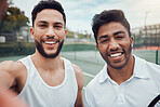 Portrait of two smiling ethnic tennis players taking selfie after playing court game. Happy ethnic athletes team standing together and bonding. Friends play competitive sports for health and fitness