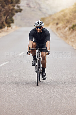 Buy stock photo Fit and active indian man wearing a helmet and sunglasses to cycle outdoors for a workout. Focused mixed race athlete exercising with a bicycle. Hispanic routine training, physical activity, healthy