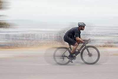 Buy stock photo One athletic young man cycling fast outside. Sporty fit male wearing helmet and glasses while riding a bike long distance with speed during a race. Endurance and cardio during a workout and training