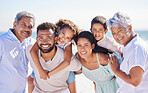 Portrait of multi generation family on vacation at the beach together. Mixed race family with two children, two parents and grandparents having fun together