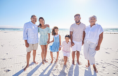 Buy stock photo Multi generation family standing together at the beach. Mixed race family with two children, two parents and grandparents spending time together by the sea
