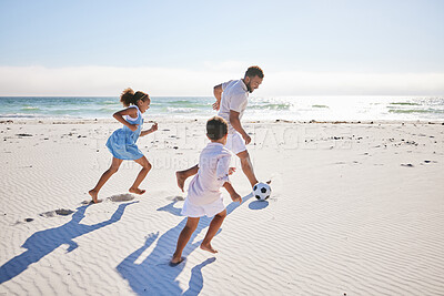 Buy stock photo Healthy father and two children playing soccer on the beach. Single dad having fun and kicking ball with his daughter and son while on vacation by the sea