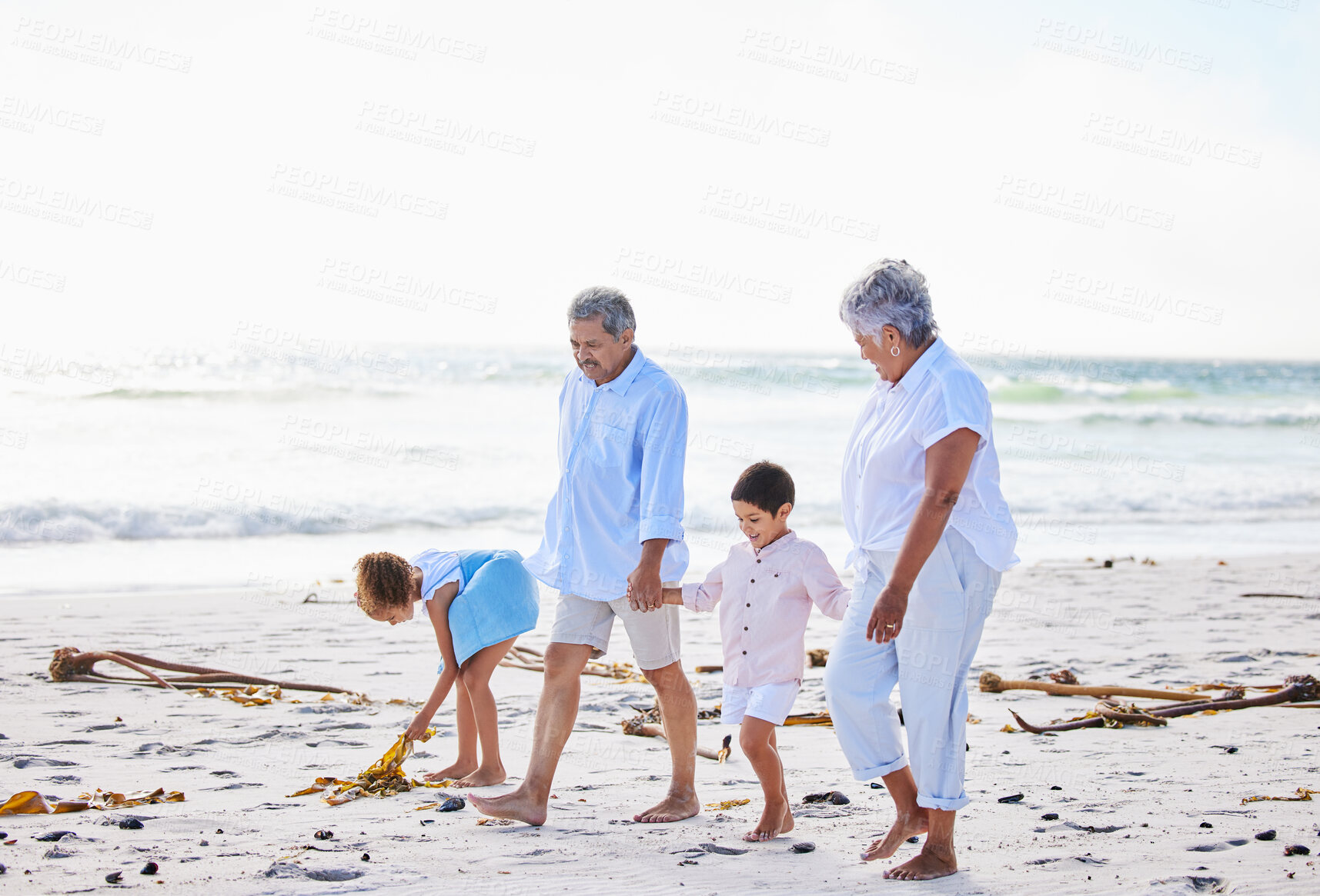 Buy stock photo Beach, grandparents or happy children holding hands, walking or smiling as a family in nature. Grandmother, senior grandfather or young kids siblings bonding or taking walk together at sea 