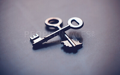 Pics of Above shot of two keys lying crossed on a table in studio. Can symbolise unlocking doors or opportunities. Could show the key to success or promotion. The key to your growth is different from the next, stock photo, images and stock photography Peo