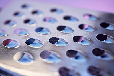 Pics of Closeup of a shiny metal grater with sharp, rough edges isolated on a purple background. Macro view of the pattern and texture of a stainless steel tool. Still life of kitchen equipment or a utensil, stock photo, images and stock photography Peopl