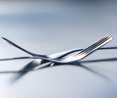Two forks side by side symbolizing togetherness, dependency and unity. A symbol of teamwork, relationship and partnership issues and troubles, or dependencies between countries or companies