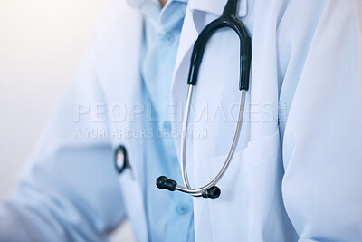 Buy stock photo Closeup of one male doctor or cardiologist wearing a white lab coat with stethoscope as uniform for work in a hospital or clinic. Trusted medical practitioner dedicated to the healthcare of patients