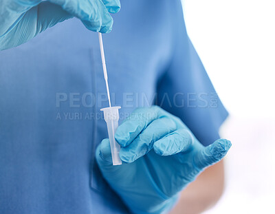 Buy stock photo Unrecognizable doctor wearing gloves and holding a cotton swab while standing against a white studio background. Unrecognizable gp preparing to use a cotton swab at a hospital