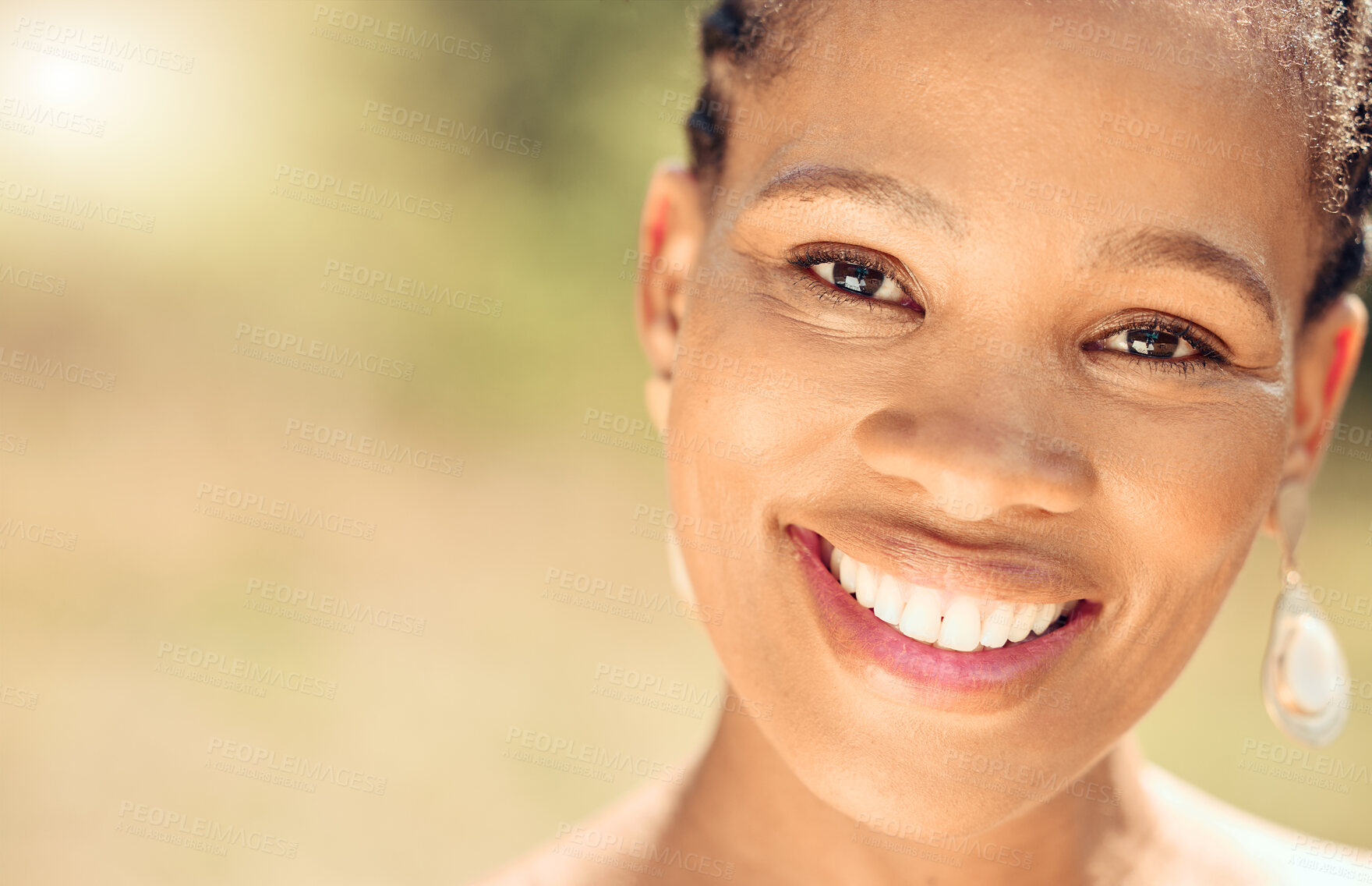 Buy stock photo Closeup portrait of a beautiful young African American woman face. Smiling black female showing her healthy teeth and perfect dental and oral hygiene while outside in the city enjoying fresh air