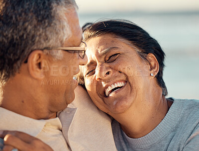 Buy stock photo A senior mixed race couple walking together on the beach  smiling and laughing on a day out at the beach. Hispanic husband and wife looking happy and showing affection while having a romantic day on the beach