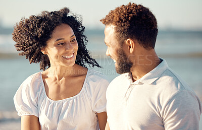 Buy stock photo Conversation, happy and couple walking on beach for summer holiday, vacation and romantic date in nature. Love, dating and mixed race man and woman talking for bonding, relax and honeymoon by ocean