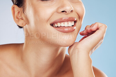 Buy stock photo Closeup face beautiful young mixed race woman. Attractive female smiling in studio isolated against a blue background. Practising good oral and dental hygiene for healthy mouth, teeth and gums