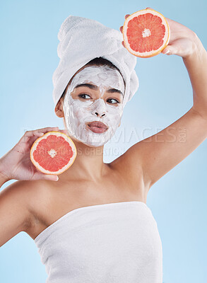 Buy stock photo Skincare, health and face mask on a woman with a grapefruit doing an organic facial in studio. Girl with wellness, selfcare and healthy lifestyle doing a body care routine with tropical citrus fruit.