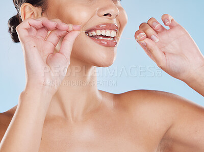 Buy stock photo Woman flossing her teeth with dental floss for oral care, healthcare and hygiene in a studio. Girl with wellness, healthy and clean lifestyle doing her mouth routine for tooth and gum health.
