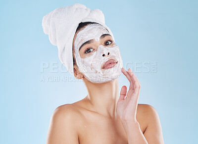 Buy stock photo Skin care, face wash and mask on woman in studio with blue background and mockup. Young model in bathroom towel in a self care, beauty or cosmetic portrait for skin health and wellness with mock up