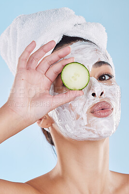 Buy stock photo Beauty skincare, skin wellness and face mask with cucumber against a blue mockup studio background. Portrait of model pouting lips, vegetable for health and cosmetic person with healthy food