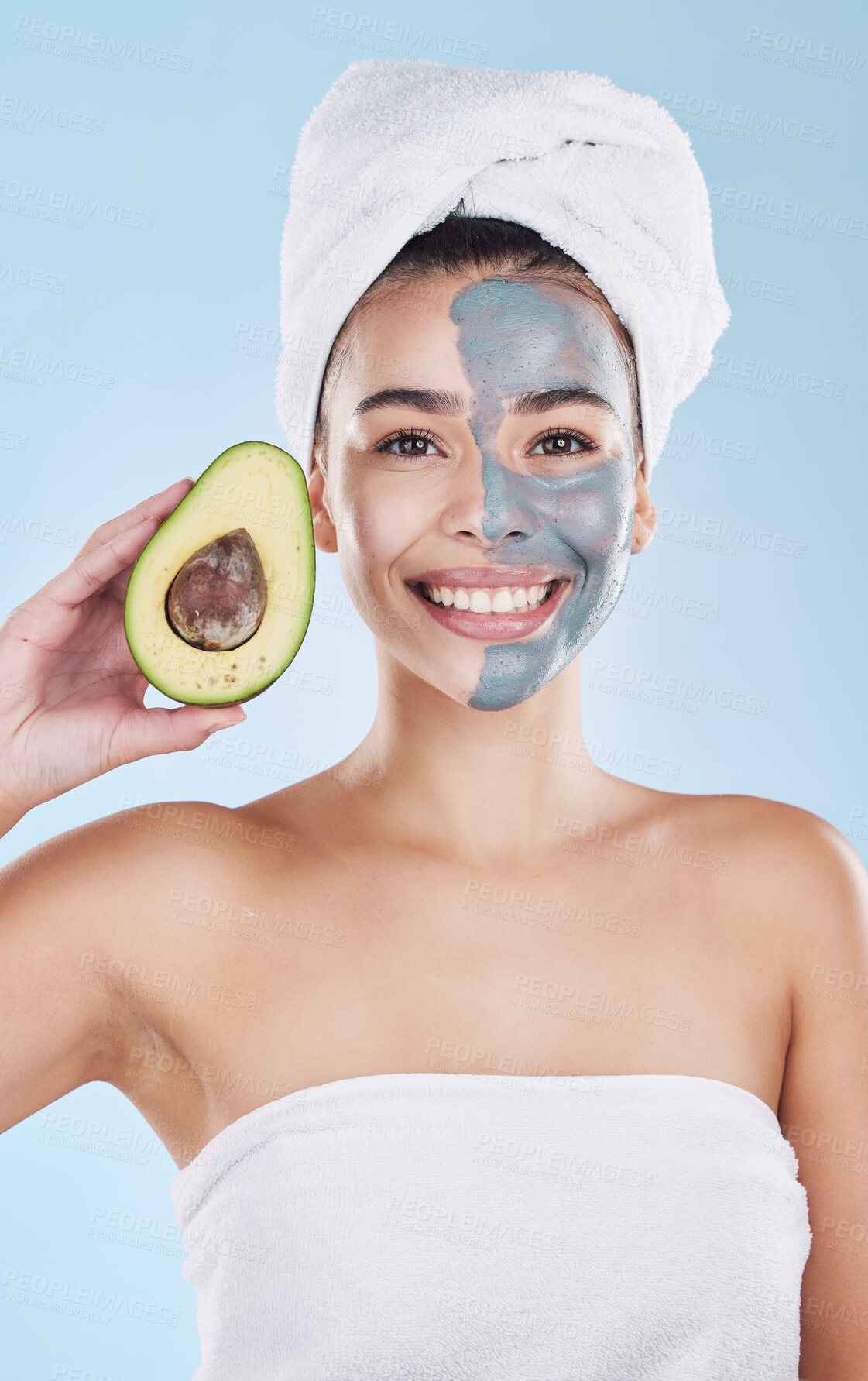 Buy stock photo Avocado face mask for beauty skincare, food for skin health and product for nutrition diet against blue mockup studio background. Portrait of happy, healthy and Brazilian girl with cosmetic fruit