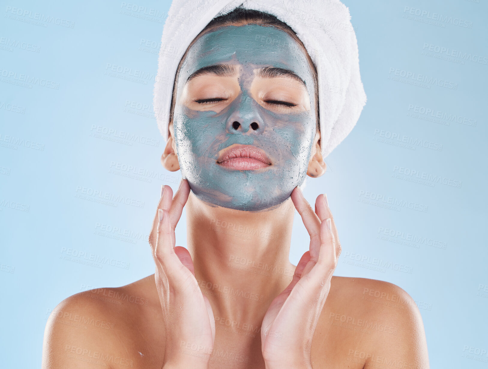 Buy stock photo Skincare, beauty and face mask on a woman while doing her wellness routine in a studio. Latina girl with fresh, body care and hygiene lifestyle doing selfcare facial treatment to relax after a shower