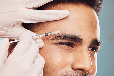 Buy stock photo Beauty, botox and eyebrow with a man in studio on a gray background for a plastic surgery injection. Hands, skincare and syringe with a young male person indoor for an antiaging facial filler closeup