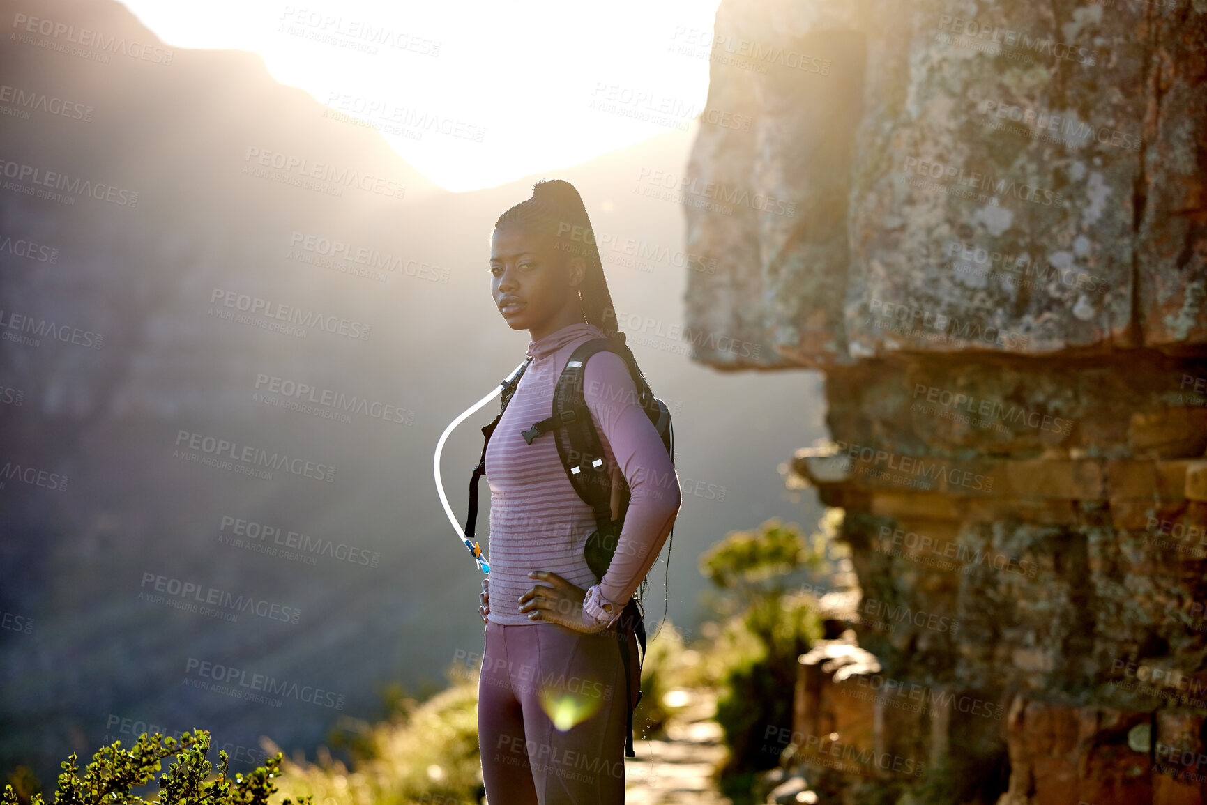 Buy stock photo Portrait, hiking and black woman in nature for exercise, adventure and travel at sunset. Hiker, fitness and female person trekking in South Africa, workout and serious training on mountain mockup.