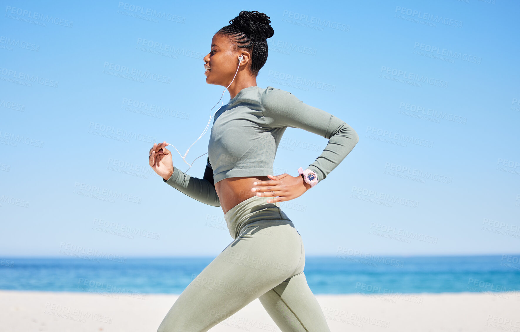 Buy stock photo Running, beach and woman listening to music, fitness podcast and training, cardio wellness and health. Ocean, blue sky and african person, runner or athlete exercise, workout and audio technology