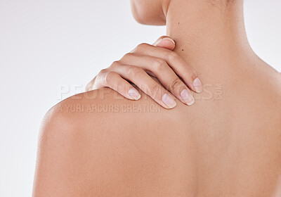 Buy stock photo Rear view of one unrecognizable model posing against a white background studio. Unknown hispanic female feeling pain in her shoulder blade while grooming