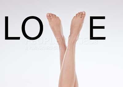 Closeup of unrecognizable woman posing against a white studio background. One female only crossing her legs to form the word love while getting ready for a romantic date by removing body hair