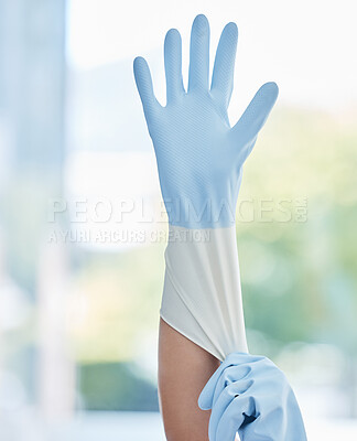 Buy stock photo Hands, housekeeper and gloves for safety cleaning, hygiene or home maintenance indoors. Hand of person or cleaner getting ready with rubber glove for sanitize, bacteria or germ removal in the house