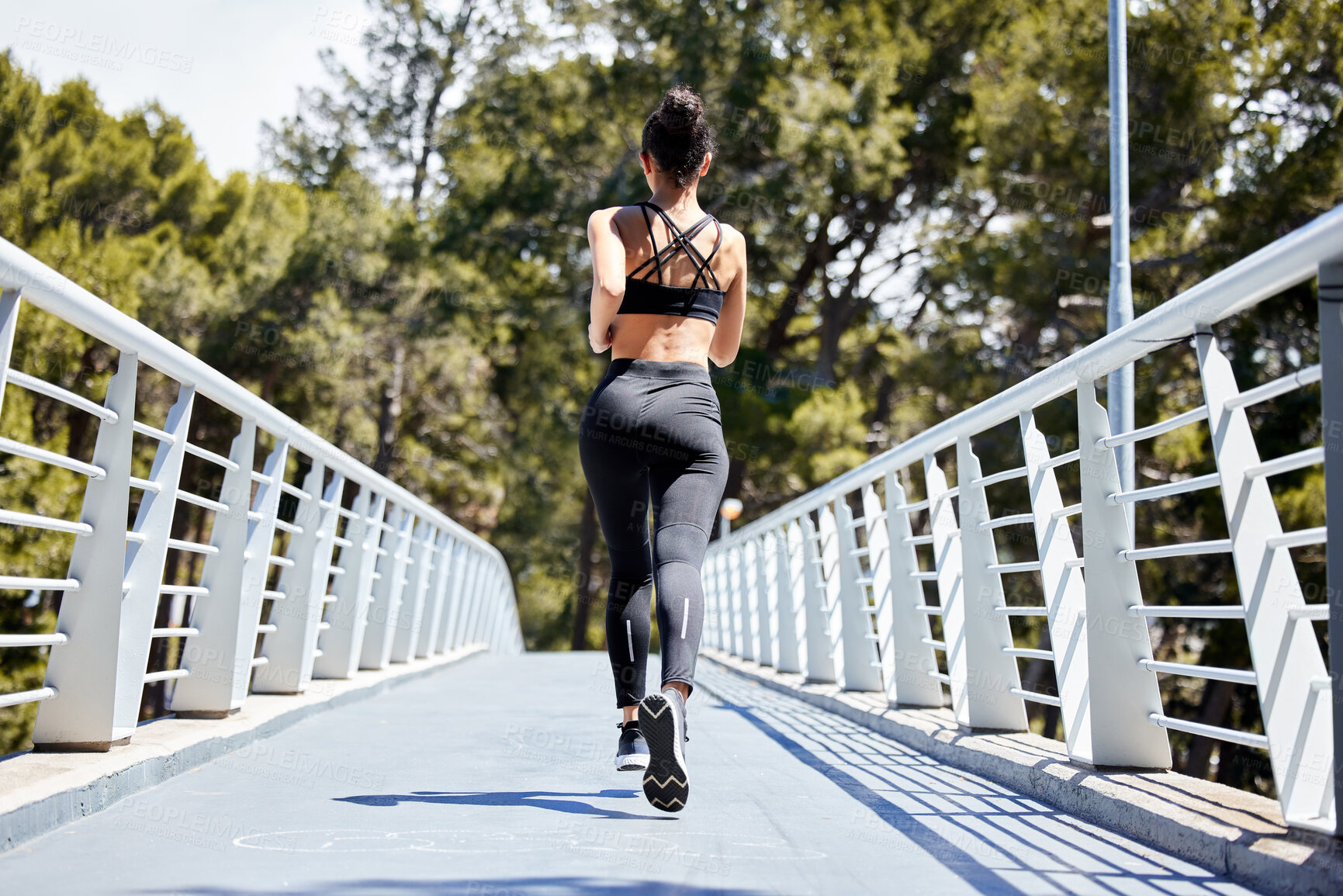 Buy stock photo Woman, fitness and running on bridge for exercise, cardio workout or training in nature outdoors. Rear view of fit, active and sports female person, athlete or runner exercising for healthy wellness